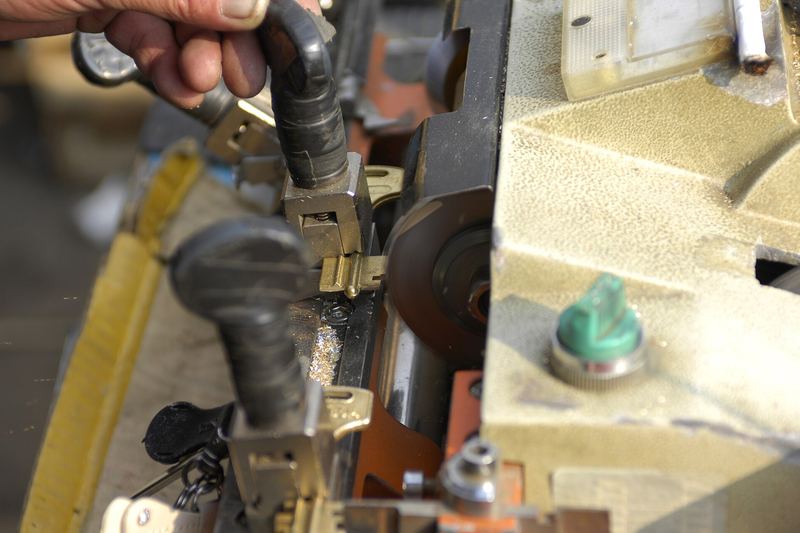 Key being cut on a key machine at a counter